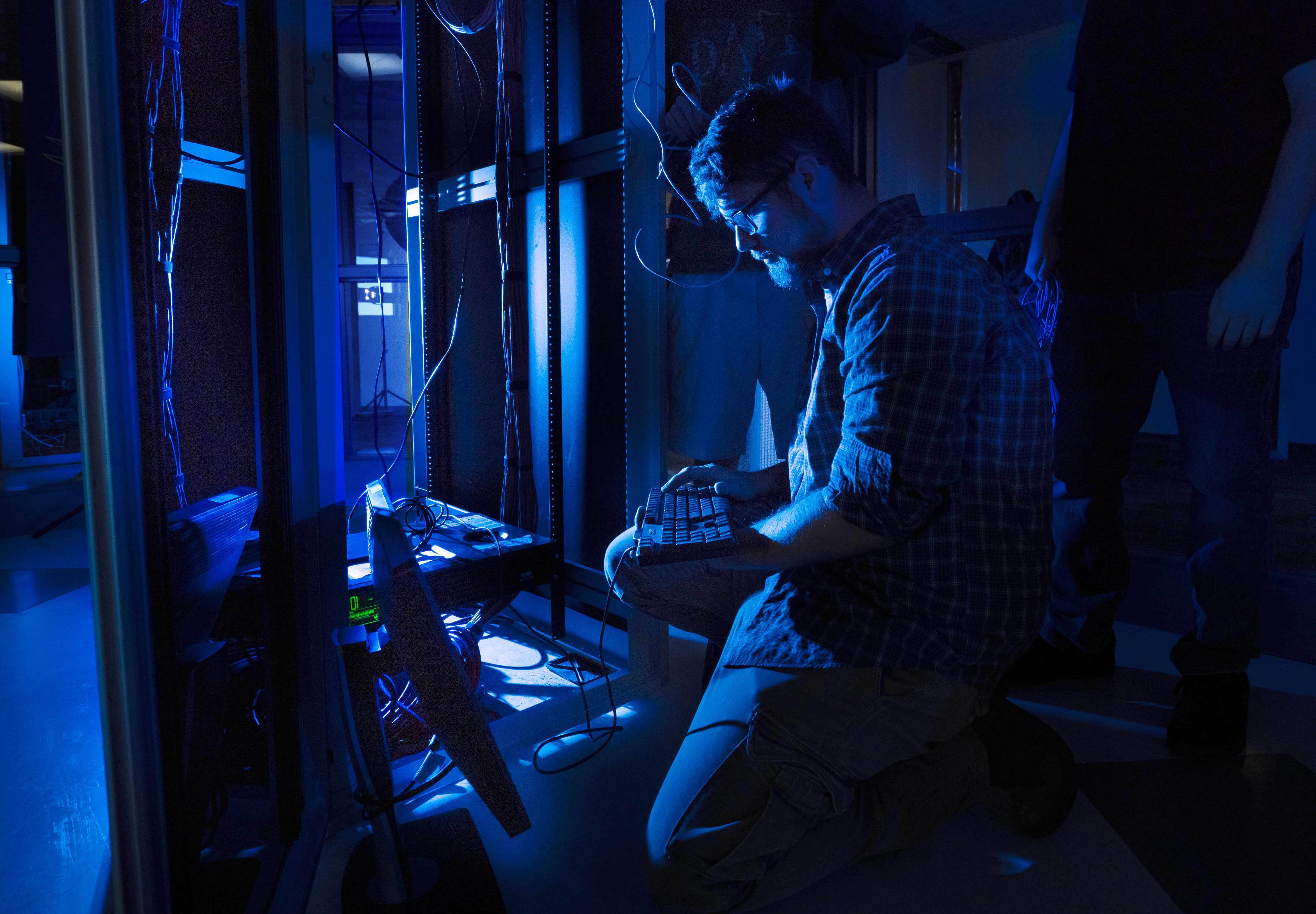 VinU student networking in a dark room.