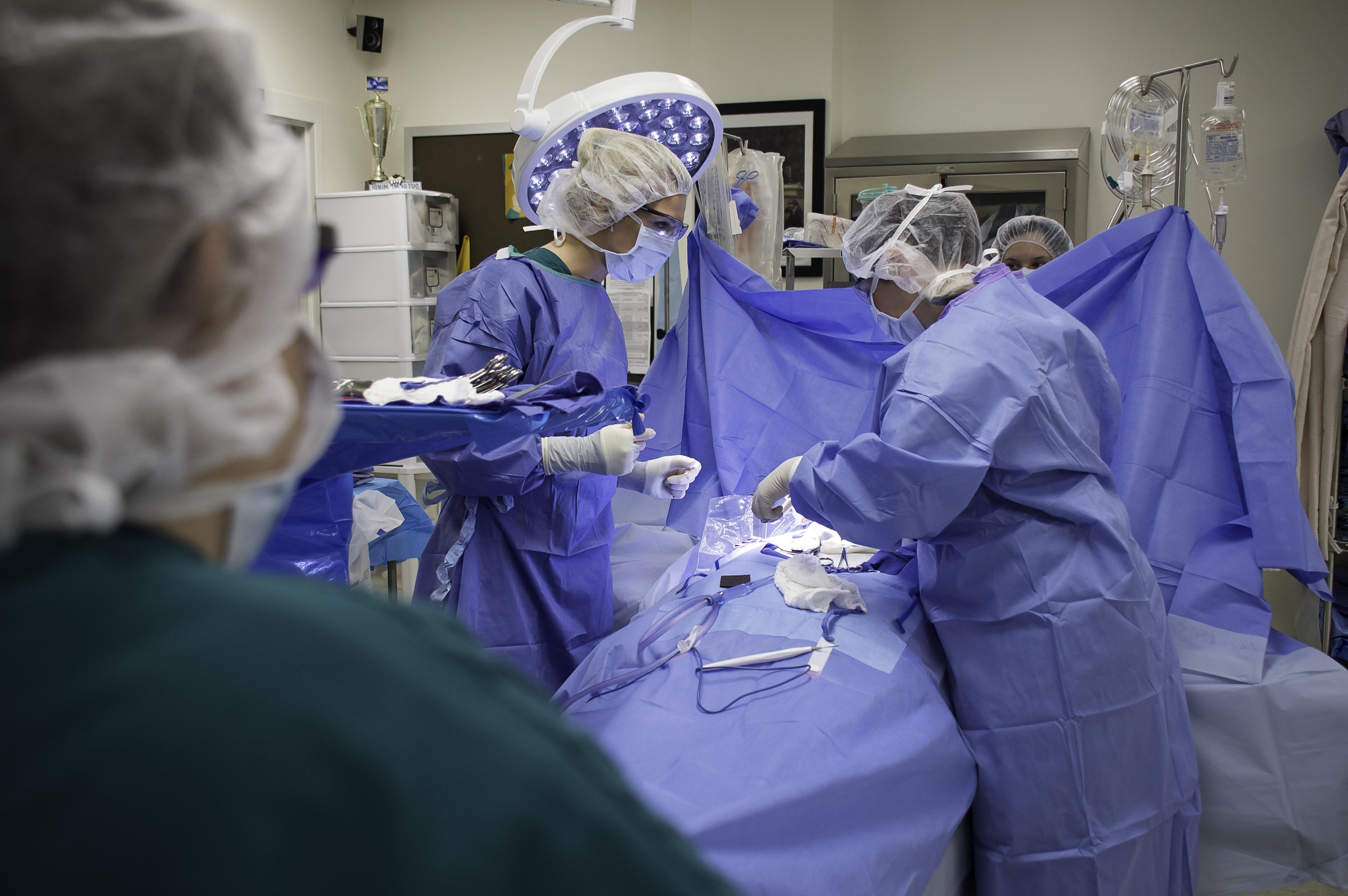 Surgeons preparing to operate on someone
