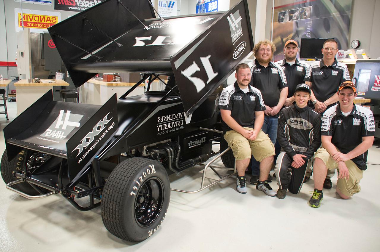 The Vincennes University Motor Sports Club posing for a photo next to a custom vehicle